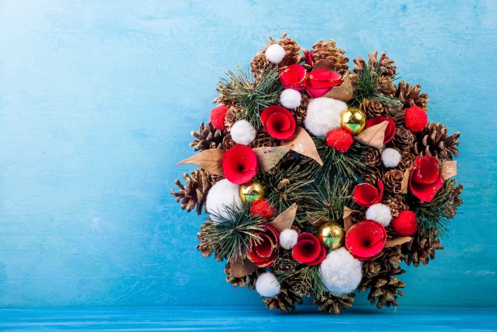 Rustic winter wedding bouquet with poinsettias, pinecones, and evergreen branches