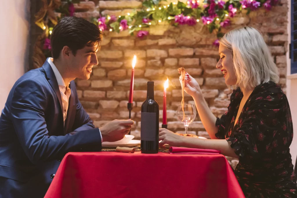 Couple at a candlelight dinner sharing a quiet, romantic moment – classic date night ideas that never go out of style.
