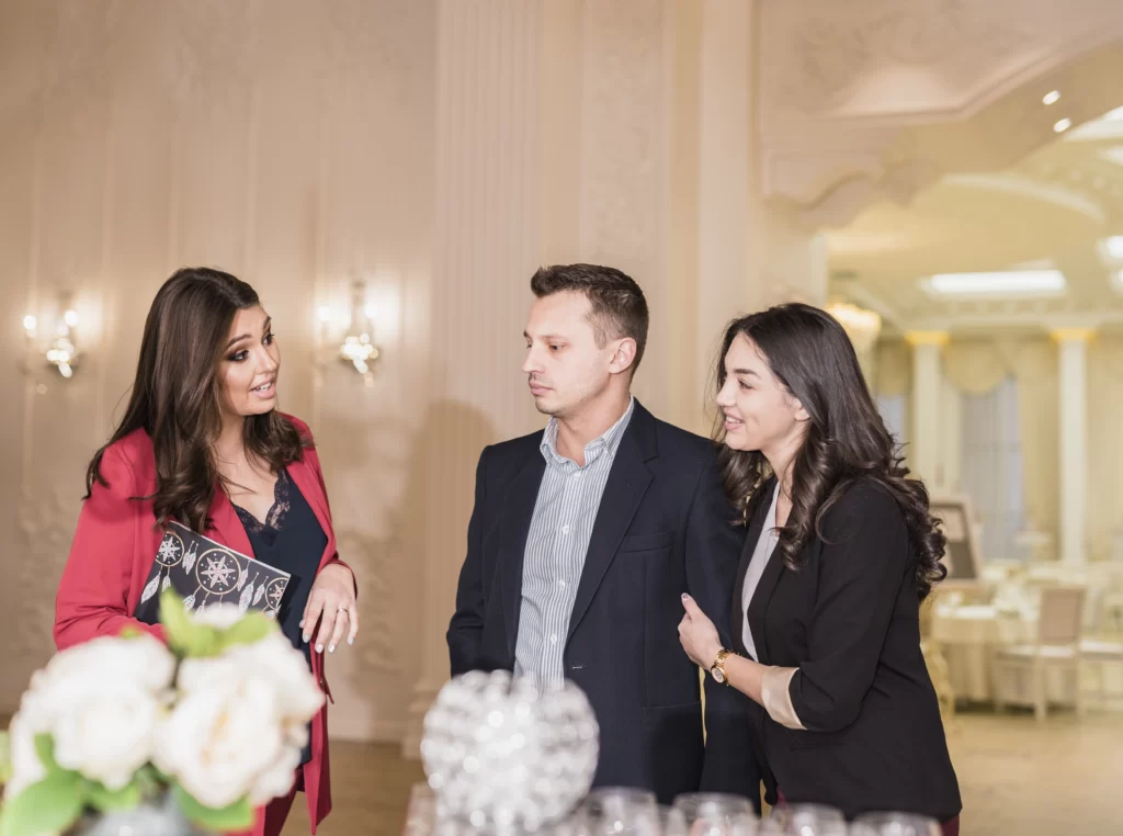 A family discussing venue costs and planning an engagement party, with parents involved in covering the venue expenses.