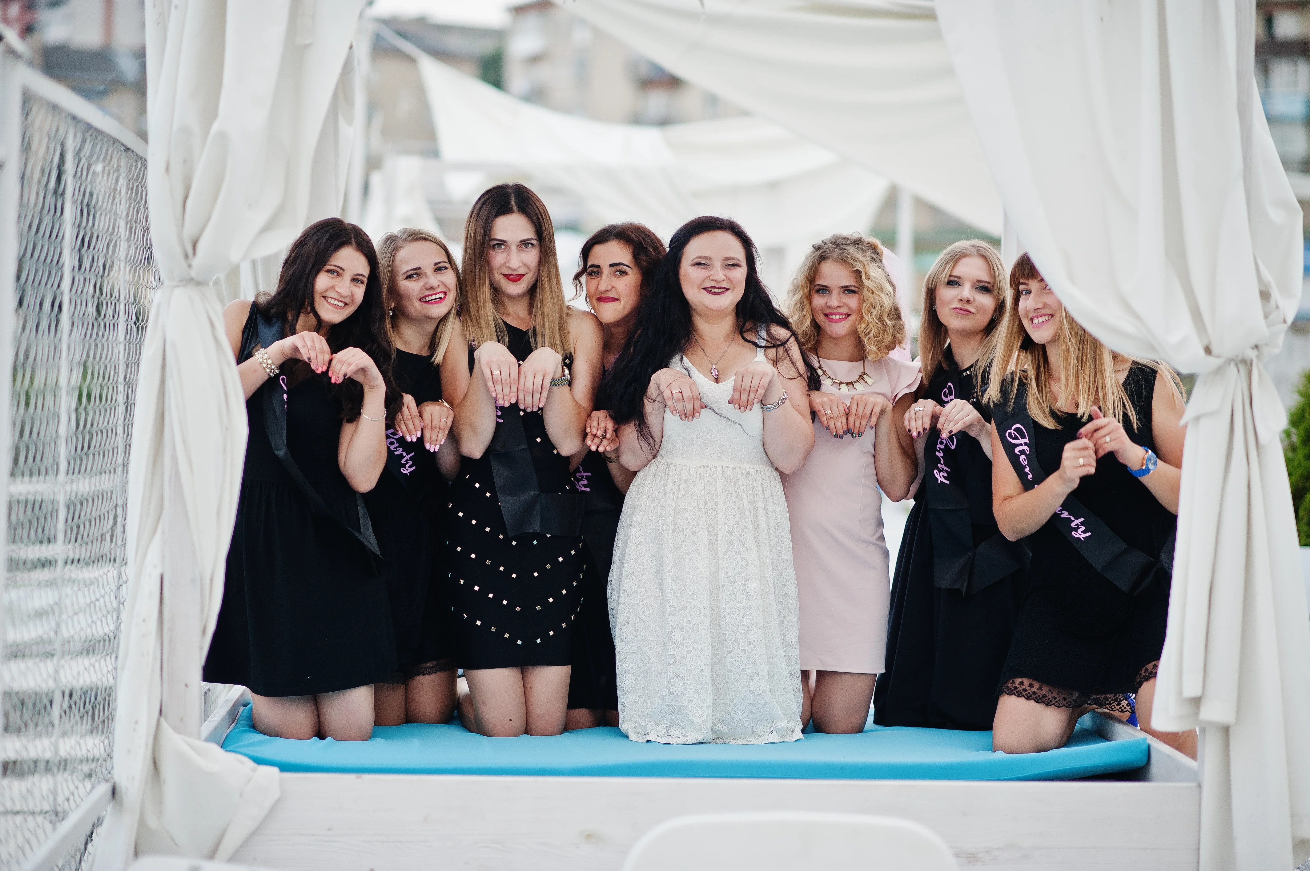 Summer Wedding guests in colorful dresses at an outdoor ceremony