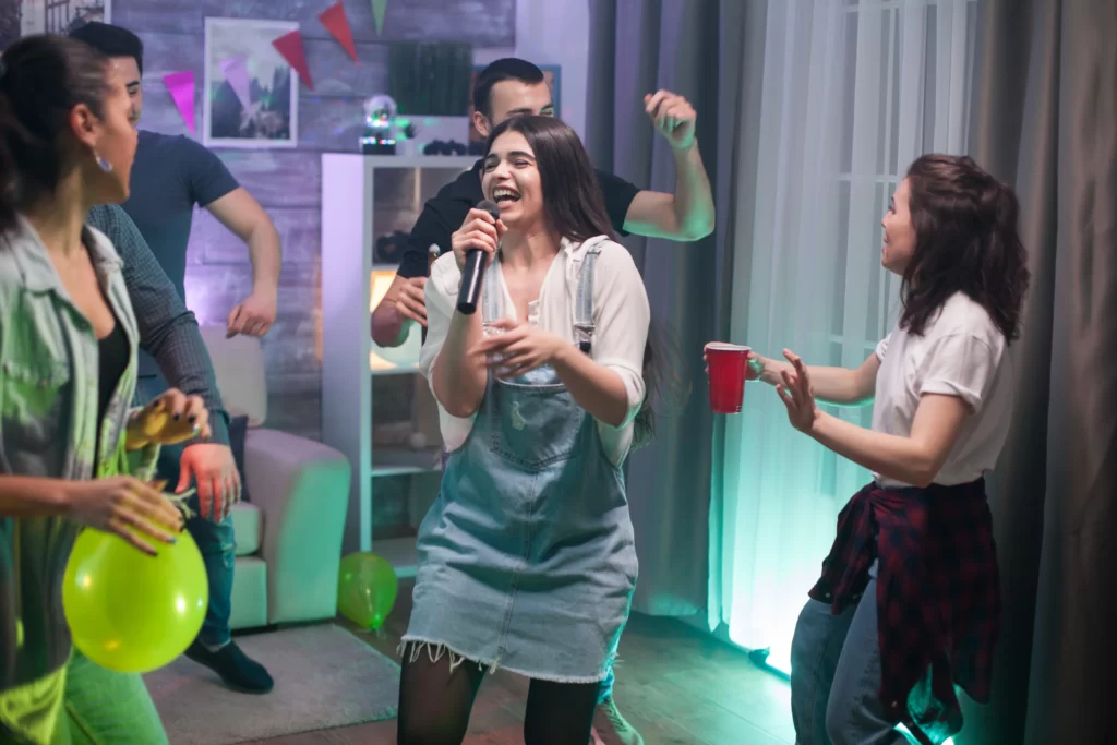 Friends having fun at a karaoke and lip sync battle for an 18th birthday.