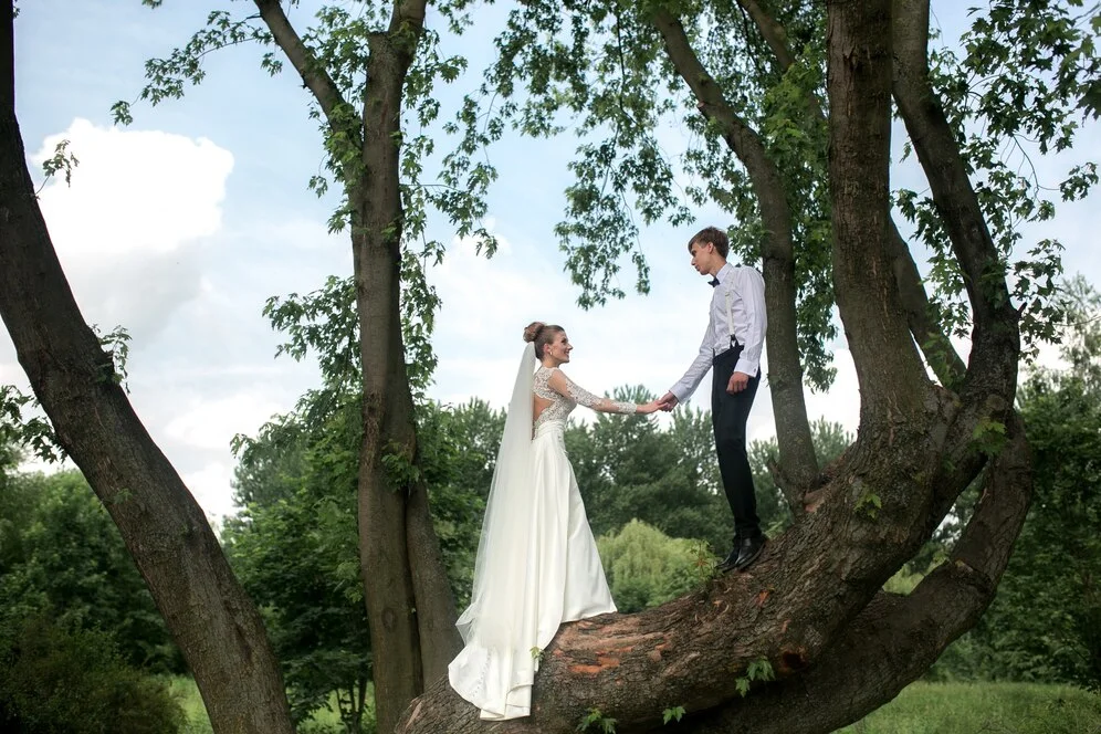 Bride and groom posed in front of a scenic venue, showcasing the environment.