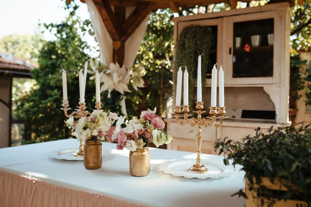 Memorial wedding table with framed photographs, glowing candles, and elegant décor.