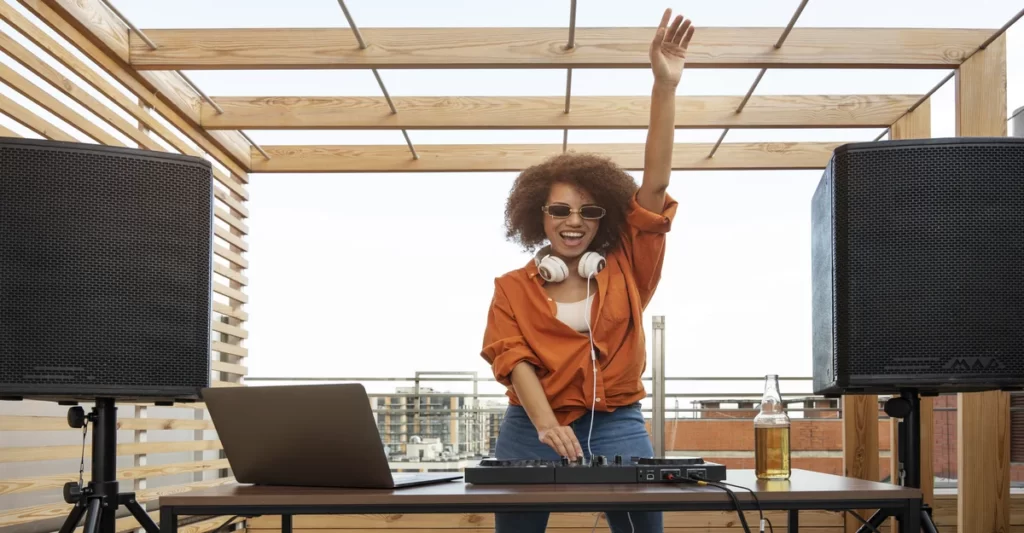 DJ performing at an outdoor party with sound equipment and lighting for a festive vibe