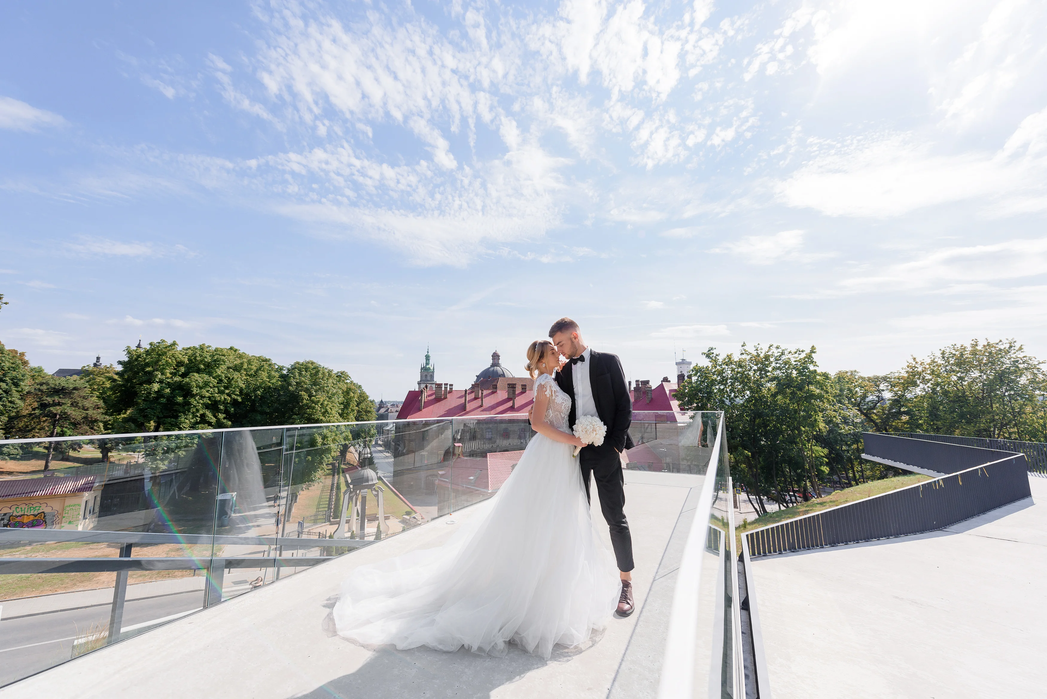 Outdoor wedding ceremony in Washington DC with floral arch and cityscape view