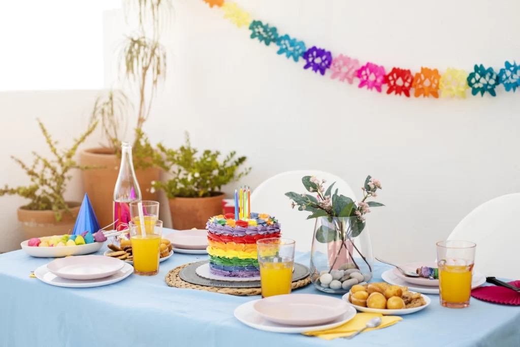 Rainbow-themed Pride party decor with balloons and colorful table settings