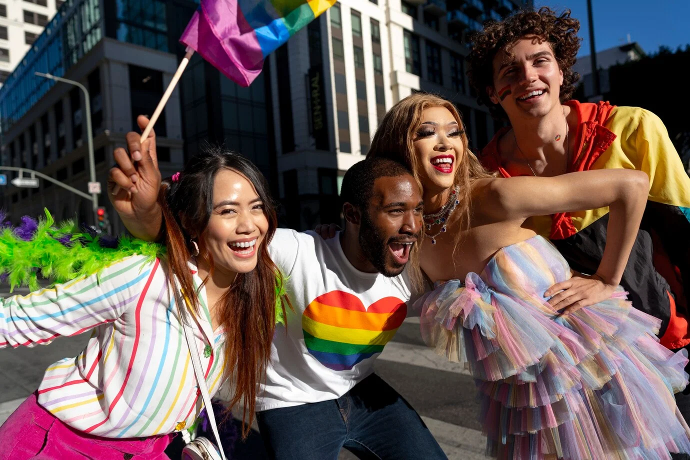 Group of friends celebrating a Pride party in Washington DC with rainbow flags and joyful expressions