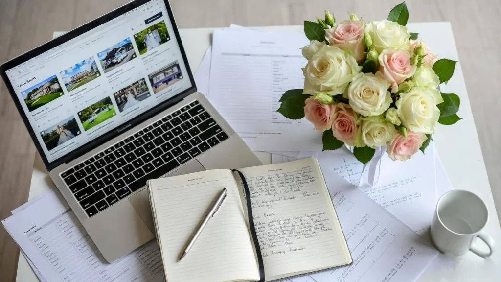 wedding planning workspace with laptop searching venues online